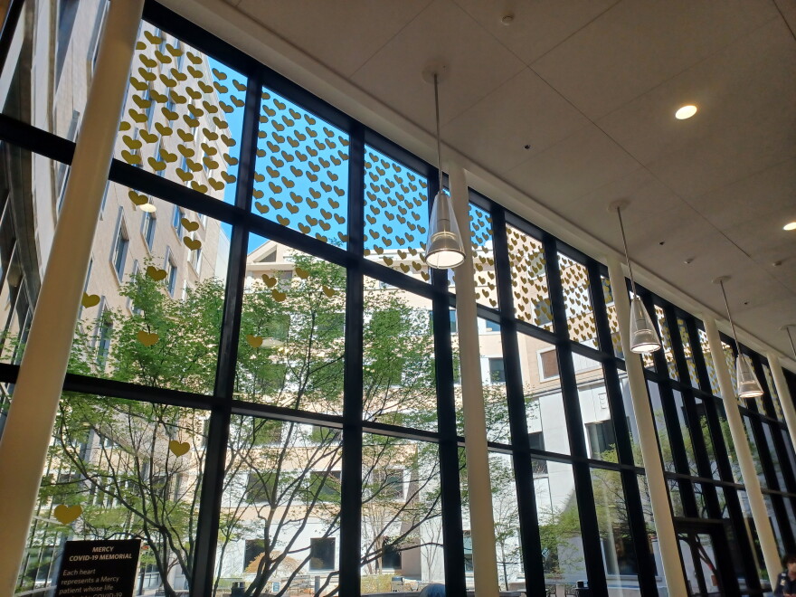 Yellow hearts grace windows at Mercy Springfield, part of a COVID-19 Memorial