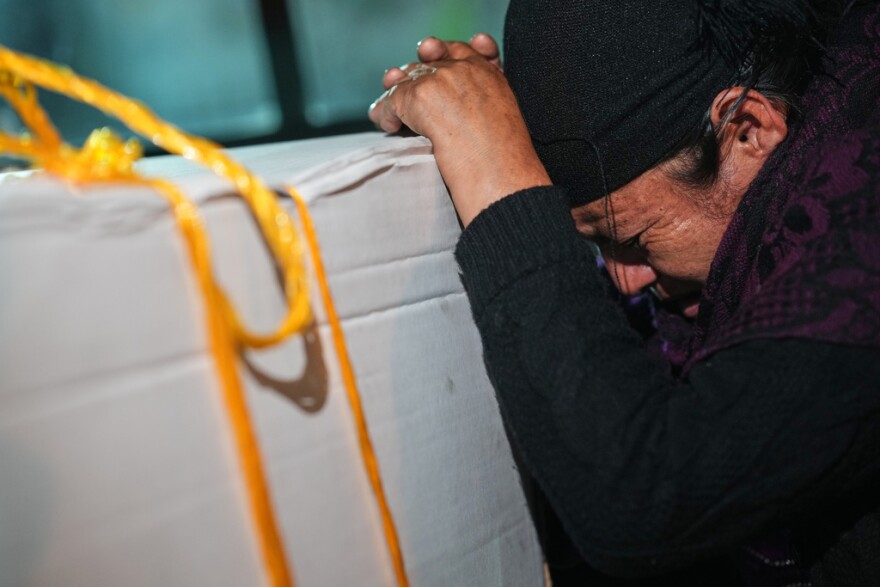 Vilma Pérez cries over the coffin of her daughter Maria Florinda Ríos Perez who was killed in Indiana, at La Aurora International Airport in Guatemala City, Sunday, Nov. 23, 2025.