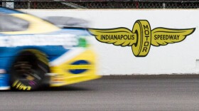 A car streaks past the Indianapolis Motor Speedway during the Brickyard 400 on Sunday, Sept. 8, 2019.