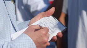 man writing on steno pad