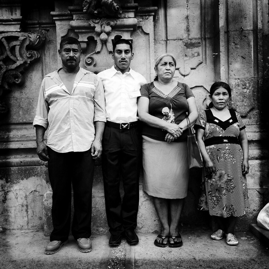 "Family Portrait After Church." Don Bernabe, left, and Dona Delfina, third from left, are the parents of missing Mexican student Adan Abrajan de la Cruz. They're posing with their godson, Marcos, and his mother, Dona Rosa. <em> </em>