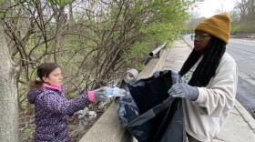 Volunteers clean up trash along the Rouge River during a recent Earth Day service event. A growing community embrace of the river is evidence of how far it has recovered from past industrial pollution and destruction.