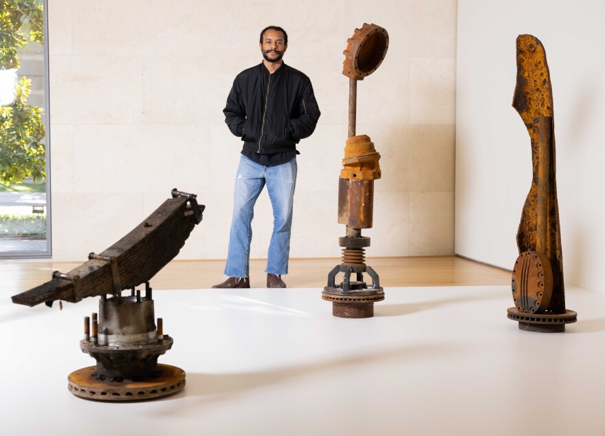 Artist Oshay Green poses next to his exhibition on display at the Nasher Sculpture Center in Dallas on Wednesday, Dec. 3, 2025.
