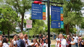 Albuquerque Mayor Tim Keller (left) alongside Bennie Hargrove's family unveil the new park sign bearing his name
