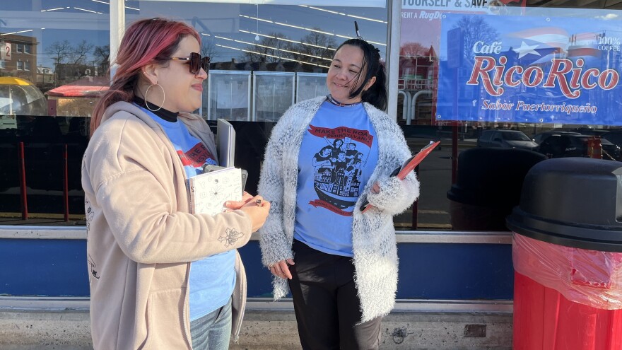 Katherine De Peña, left, a field organizer in charge of Make The Road Pennsylvania's voter registration program, and her colleague Mayra Del Toro wait to greet eligible voters in Spanish outside a CTown supermarket in Reading, Pa.