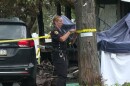 A police officer ties caution tape to a pole at the scene of a fatal house fire in Shavertown, Kingston Twp., Luzerne County on Wednesday, Aug. 5, 2026.