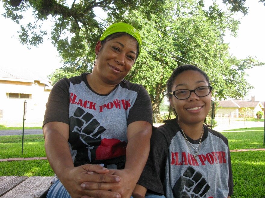 Angelique Mitchell, with her daughter, Ariel, says the community was kept in the dark about the giant grain terminal next door, and their own parish council refuses to put it on the agenda.