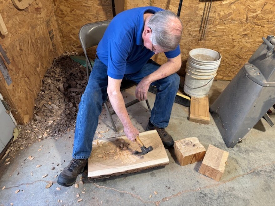 McWhorter chips away pieces of wood to form a bowl