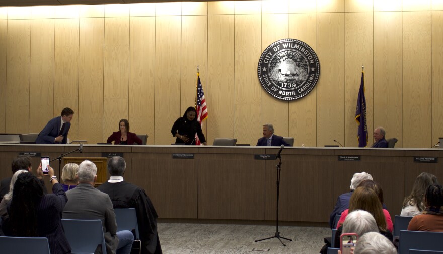Chakema Clinton-Quintana takes her seat at the dais after being sworn in