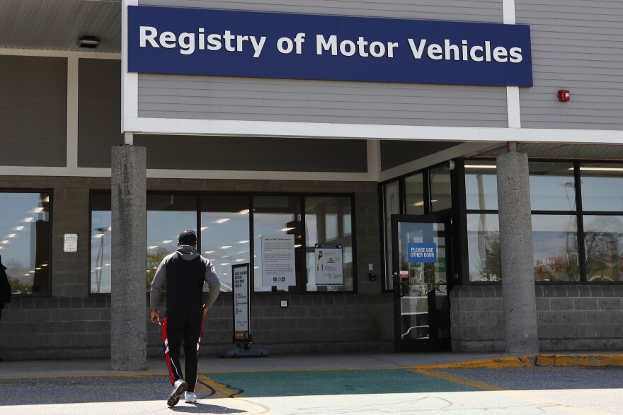 A man walks to the Commonwealth of Massachusetts Registry of Motor Vehicles office in Lawrence, Massachusetts.