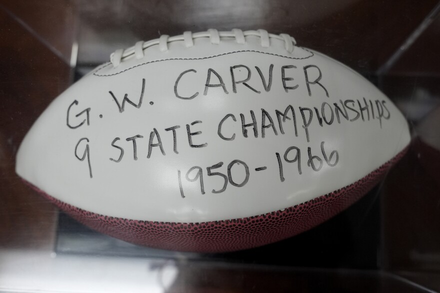 A football with the name of George Washington Carver School is displayed