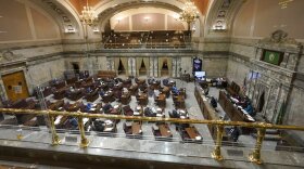 Legislators work on the Washington Senate floor at the Capitol in Olympia, Wash., on Tuesday, Feb. 15, 2022, during debate over a measure that authorizes legislative leaders to terminate any state of emergency called by the governor after 90 days if the Legislature is not in session. The measure passed the Democratic-led Senate chamber and now heads to the House, also held by Democrats, for consideration.