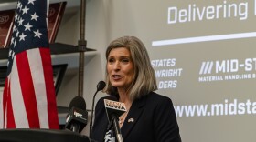 joni ernst speaks at a podium