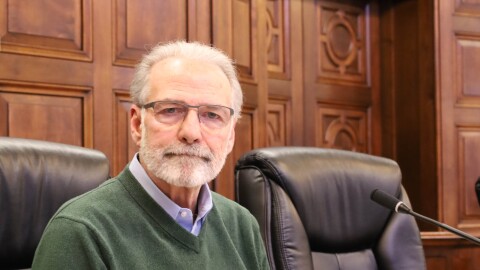 Akron Council Vice President Jeff Fusco sits at his desk in the city's chambers. Fusco is retiring after working for the city of Akron 40 years.