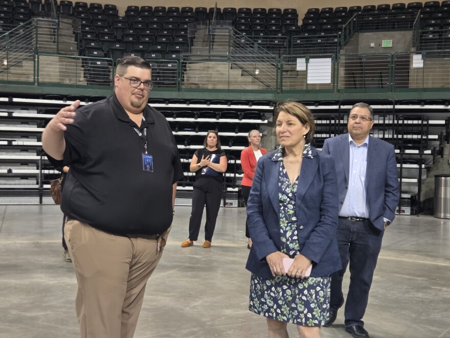 Sanford Center General Manager Bobby Anderson, left, describes the damage to the arena and equipment from the June 21 windstorm during a visit with Sen. Amy Klobuchar, right, on July 25, 2025.