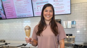 Ellie Darr, owner and CEO of Genuine Ice Cream, holds a house-made waffle cone with a generous scoop of Salted Caramel Oreo