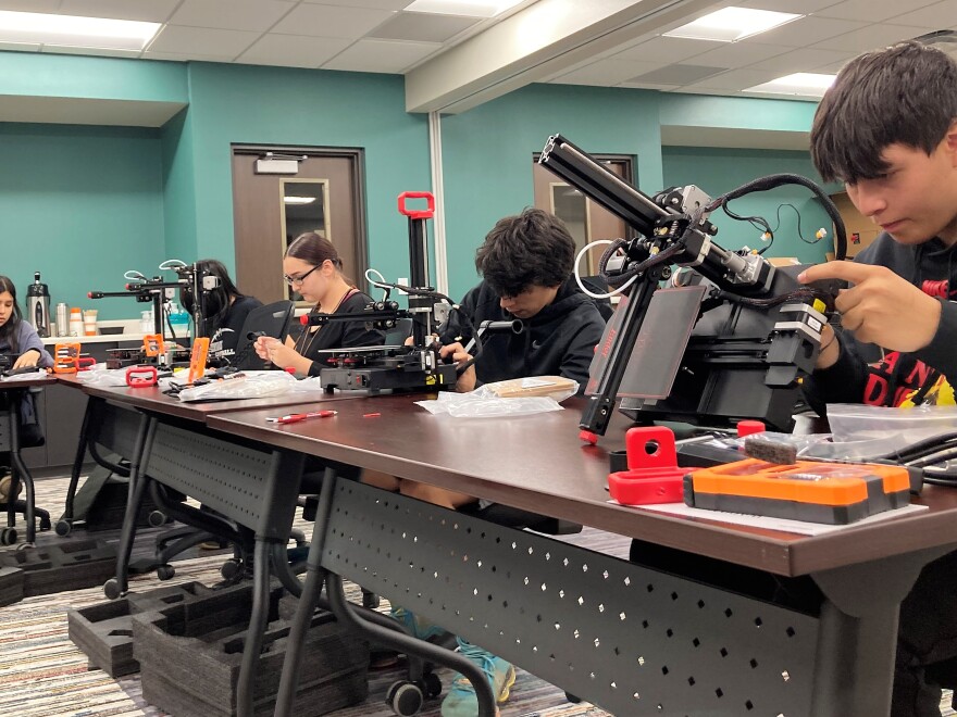 Students construct 3D printers during a class in Lac du Flambeau.