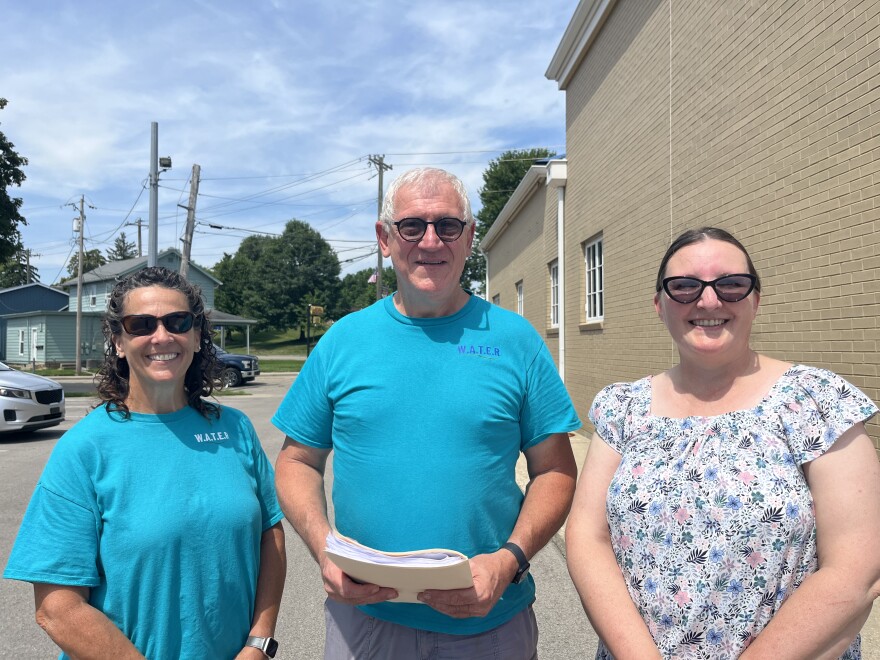 Amy Humbert and Barry and Lorie Blankenship stand outside Trenton's city building.