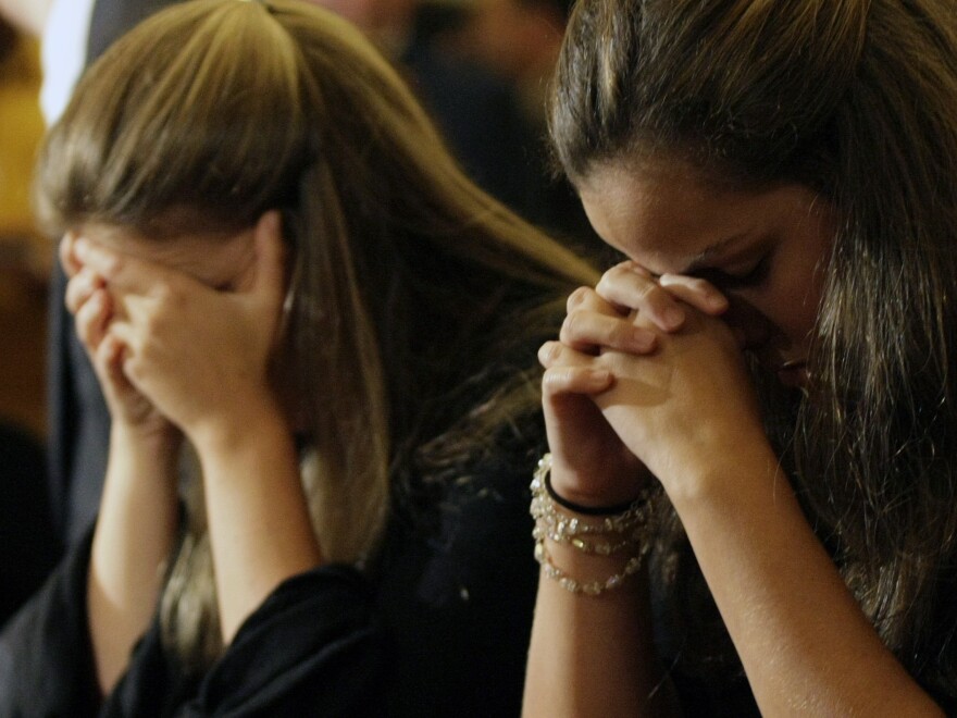June 5, 2009: Relatives and friends pray for passengers of Air France Flight 447 at the Nossa Senhora do Carmo church in Rio de Janeiro. Those who lost loved ones in that flight are expressing their sympathy and concern for those waiting for word about Malaysia Airlines Flight 370.