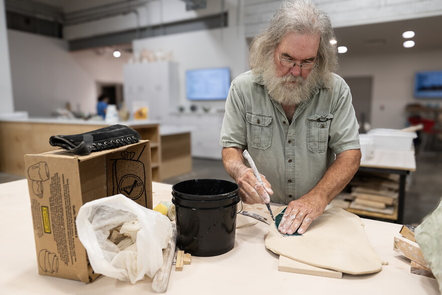 Retired art teacher Bob Putnam works on a slab-built pitcher at a worktable in the KC Clay Guild’s new Ceramic Arts Center in Midtown. Putnam has been a member of the Guild for 38 years and will be teaching classes at the center starting in October.