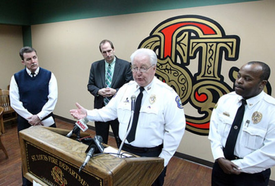 Hazelwood Police Chief Carl Wolf (center) speaks at a press conference about red light cameras today.