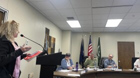 Antrim County Clerk Victoria Bishop (seated at the left end of the table) listens as a resident addresses the county commission during a meeting earlier this month.