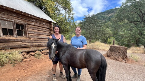 Ruby Ranch owner Kim Ibarra and equine specialist Laura Williams stand with their Welsh pony Simon who currently is in training to become a therapy horse.