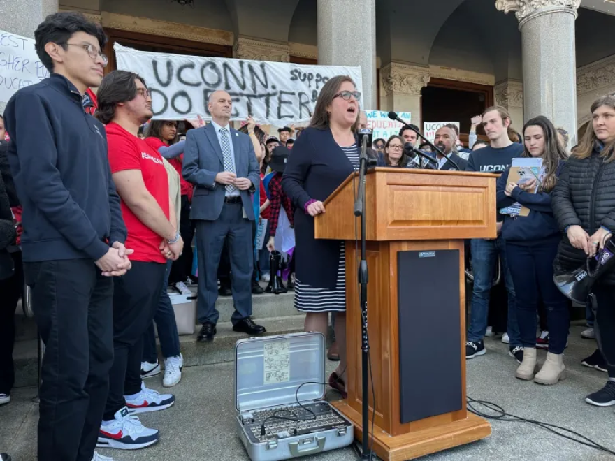 Sen. Mae Flexer addresses UConn students. Behind her is Rep. Greg Haddad. The districts of both lawmakers are home to UConn.