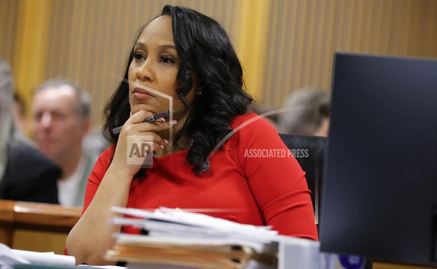 FILE - Fulton County District Attorney Fani Willis looks on during a hearing on the Georgia election interference case, Friday, March, 1, 2024, in Atlanta. A progressive Democrat and a Republican who briefly worked in Donald Trump's administration entered the Fulton County district attorney's race Friday, March 8, 2024, as the current officeholder, Willis, awaits a judge's decision on whether she will be removed from the Georgia election interference case against the former president. (AP Photo/Alex Slitz, Pool, File)