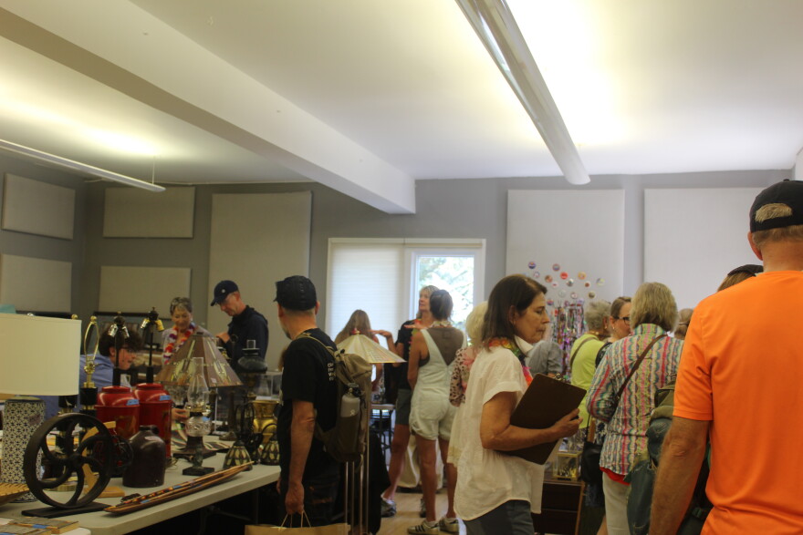 Shoppers browse through goods at one of the Aspen Thrift Shop’s annual art sale rooms on Saturday, Aug. 8, 2026, in Aspen. This room included pottery from Toklat, tea sets and works from Salvador Dali.