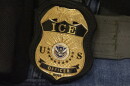 FILE - A federal agent wears an Immigration and Customs Enforcement badge in New York, June 10, 2025. 