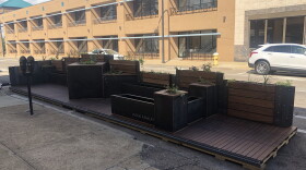 The pocket park is built on a platform that sits atop several parking spaces on North High Street in Akron.