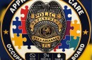 This TPD decal has a badge and the words "Approach with care. Occupant with autism on board."