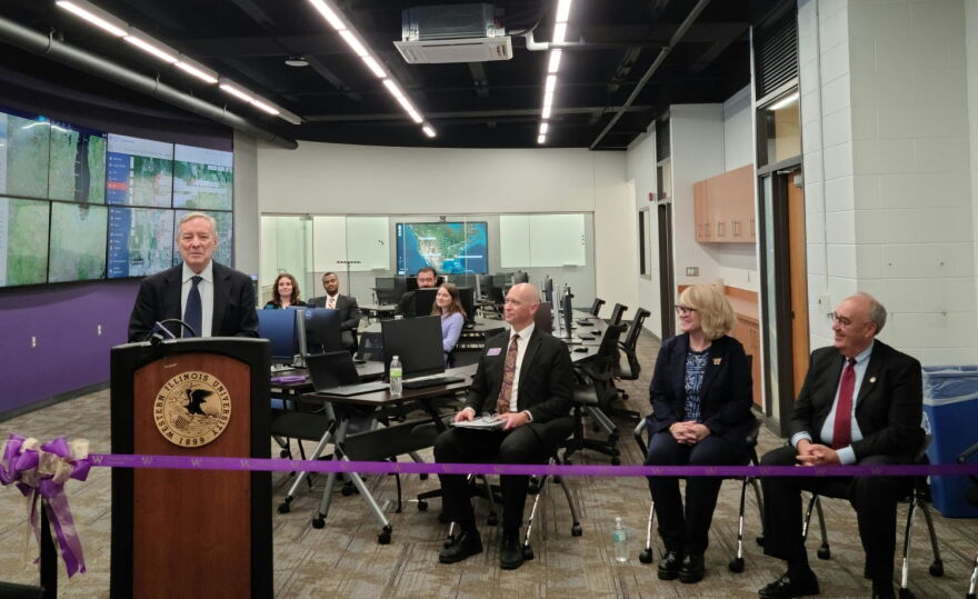 U.S. Senator Dick Durbin (at the podium) addresses the crowd at the ribbon-cutting ceremony. Jamie Johnson, Director of the School of Law Enforcement and Justice Administration; WIU President Kristi Mindrup; and Macomb Mayor Mike Inman (seated left to right in the foreground) were also there along with faculty and students seated in the background.