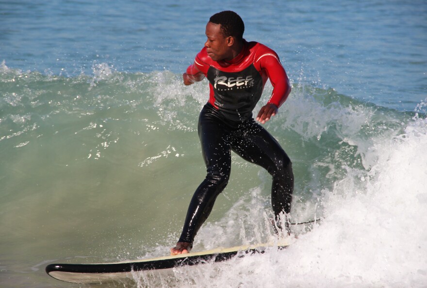 Mntanywa catches a wave at Monwabisi Beach.
