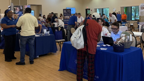 Residents walk around and talk with various community health organizations at the Health Fair and Falls Expo at the Alachua County Senior Recreation Center.