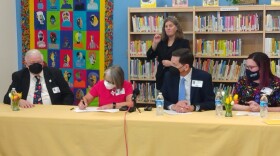 Gov. Michelle Lujan Grisham signs an Executive Order to eliminate 25% of state mandated education paperwork as (l-r) NEA-New Mexico Interim Executive Director Charles Bowyer, Public Education Secretary Kurt Steinhaus, and Whitney Holland, President of the American Federation of Teachers-New Mexico look on.