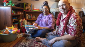 Felicia and Rick LeClair in their home, surrounded by books and toys. (Robin Lubbock/WBUR)