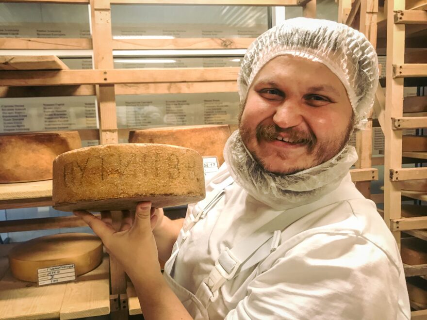 Sirota shows off a wheel of cheese with Vladimir Putin's name. He's been saving it especially for the Russian president, but so far has had no luck delivering it.