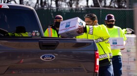  Austin Water crews give out bottled water at the Koenig Lane distribution center on Sunday.