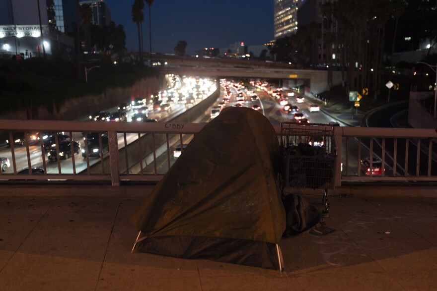 A homeless person's tent sits on a bridge over the 110 Freeway in Los Angeles. (AP Photo/Jae C. Hong)