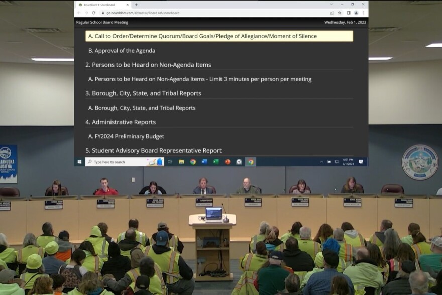 people in yellow shirts in a meeting room