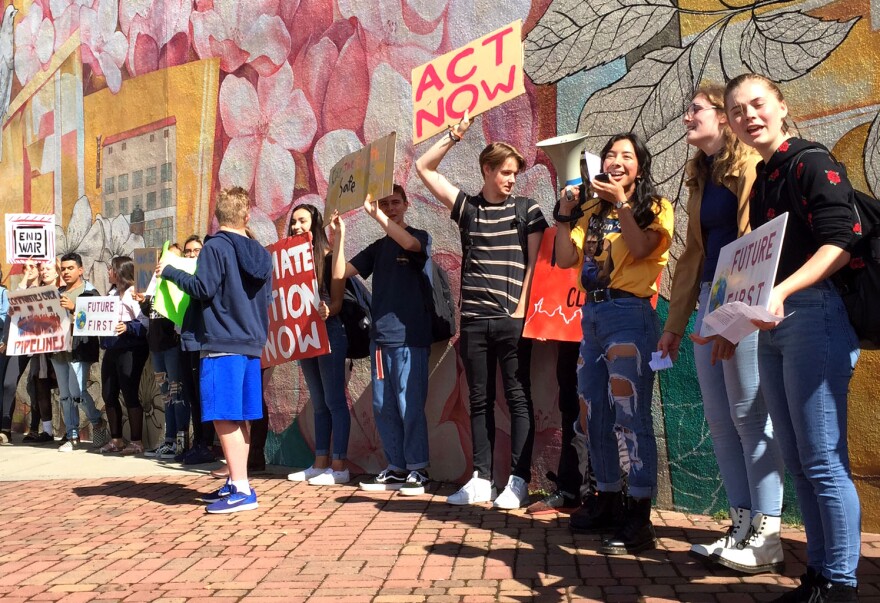 Image of students chanting with signs.