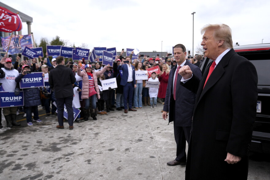 Republican presidential candidate former President Donald Trump greets supporters as he arrives at a campaign stop in Londonderry, N.H.