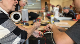 a woman and boy work on a repair project at a Fixit Clinic