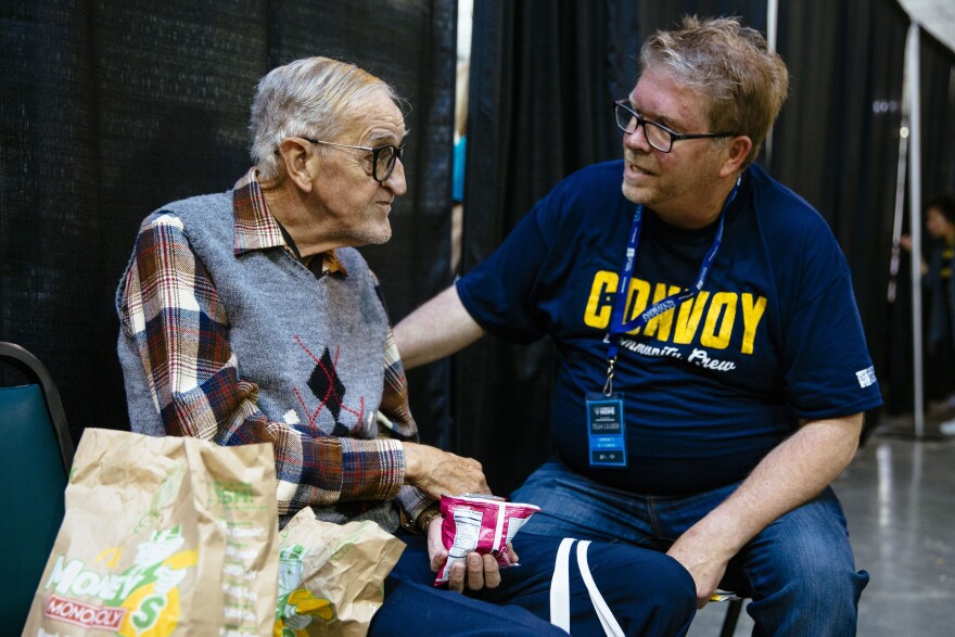 Volunteer talking to an elderly man