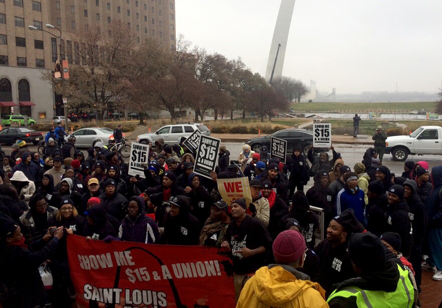 Fast food workers and their supporters pause in front of the Gateway Arch during a march for $15 an hour on Thursday, December 4, 2014.