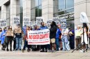 Robert Dawkins, political director for Action NC, addresses a crowd gathered in front of the Charlotte-Mecklenburg Government Center.