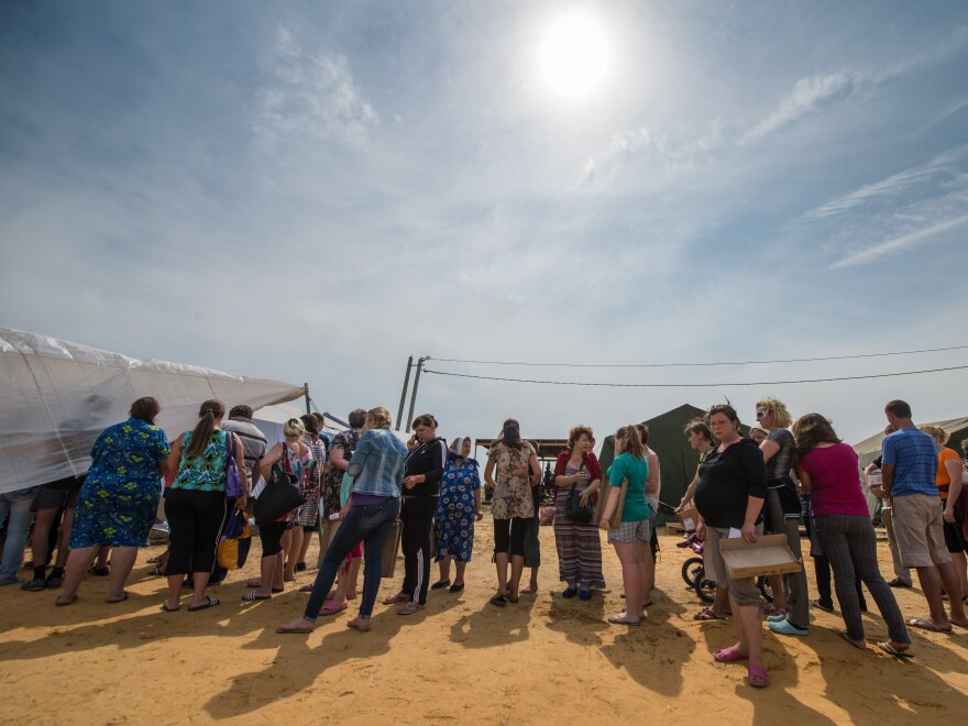 Refugees from eastern Ukraine queued to get food in a refugee camp near the city of Donetsk, near the Russian-Ukrainian border, in August 2014.