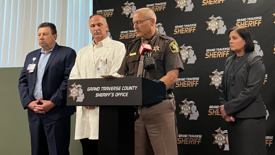 Grand Traverse County Sheriff Michael Shea briefs reporters on Sunday afternoon, the day after a stabbing attack at the Walmart Supercenter in Garfield Township. With him, from left to right, are Joe Hurshe, president and CEO of Munson Medical Center; Dr. Tom Schermerhorn, chief medical officer at Munson; and Grand Traverse County Prosecutor Noelle Moeggenberg. (Photo: Claire Keenan-Kurgan/IPR News)